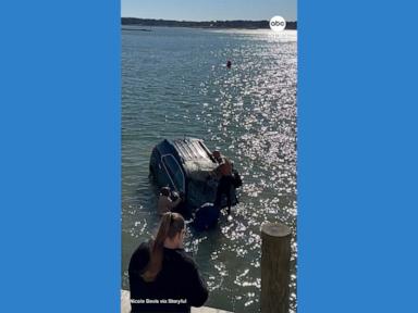 WATCH: Bystanders help rescue driver trapped inside sinking SUV